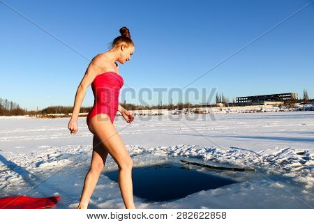 Young Woman Crosses Herself Plunging Into Icy Water During Ukraine
