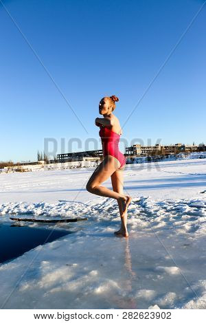 Young Woman Crosses Herself Plunging Into Icy Water During Ukraine