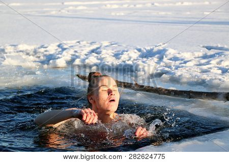 Young Woman Crosses Herself Plunging Into Icy Water During Ukraine