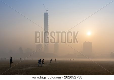 Beautiful Image Of Sunrise At Kolkata Maidan In A Foggy Winter Morning. Sunrises At The Horizon Abov