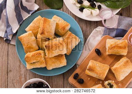 Spinach Puffs With Feta Cheese On Cutting Board.