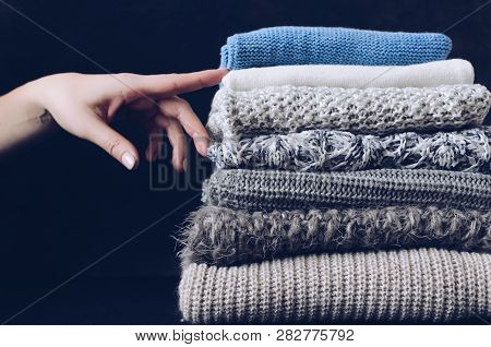 Pile Of Knitted Woolen Sweaters. Clothes With Different Knitting Patterns Folded In Stack. Warm Cozy