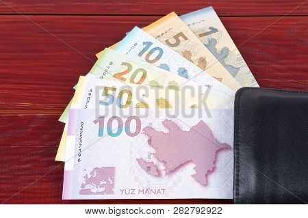 Azerbaijani Manat In The Black Wallet On A Wooden Background