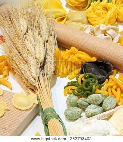 Italian Homemade Pasta With Various Formats Called Tagliatelle Tortellini And Ears Of Ripe Wheat And