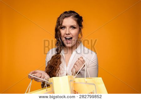 Picture Of Beautiful Smiling Young Woman In White Blouse Holding Cruft Bags After Shopping