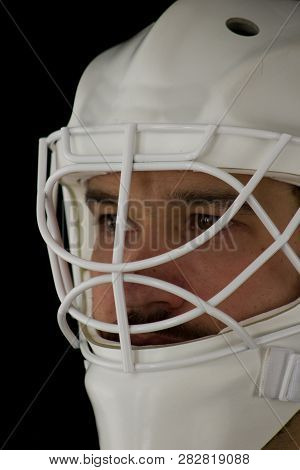 Detail Of A Male Face In A White Goalie Hockey Mask.this Is A Detail Hockey Goalie. He Is Concentrat