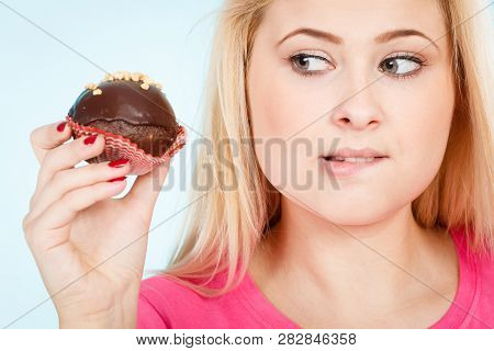 Diet, Sweets, Food Concept. Woman Holding Delicious Chocolate Cupcake With Peanut Frosting About To 