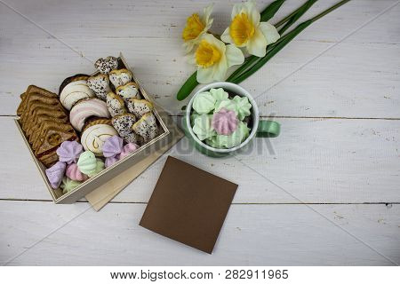 Box Of Sweets On A White Background. With Flowers. Cup With Colored Meringues. Box Of Cookies For Va