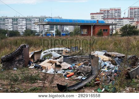 Illegal City Dump In The Dry Grass, Near The Gas Station. Outskirts Of A Big City.