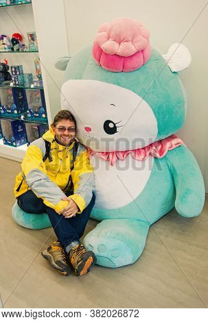 Reykjavik, Iceland - October 12, 2017: Man Traveler With Hello Kitty Toy. Leisure Traveler Man. Hell