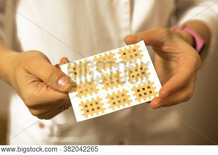 Female Hands Close-up Sticks A Patch On Their Face Against Aging. Tape For Facelift With Kinezio. Cr