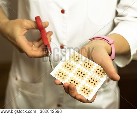 Female Hands Close-up Sticks A Patch On Their Face Against Aging. Tape For Facelift With Kinezio. Cr