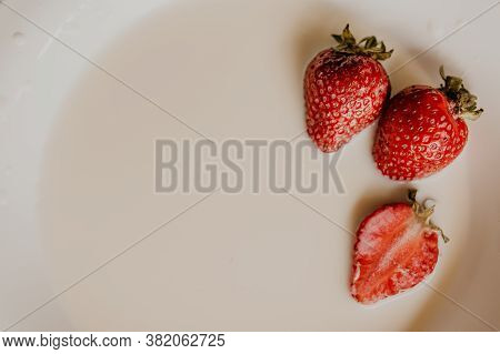 Juicy Red Strawberry Lies On The Wooden Board