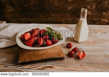 Juicy Red Strawberry Lies On The Wooden Board