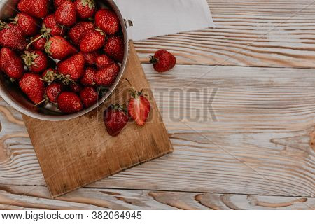 Juicy Red Strawberry Lies On The Wooden Board