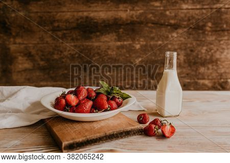 Juicy Red Strawberry Lies On The Wooden Board