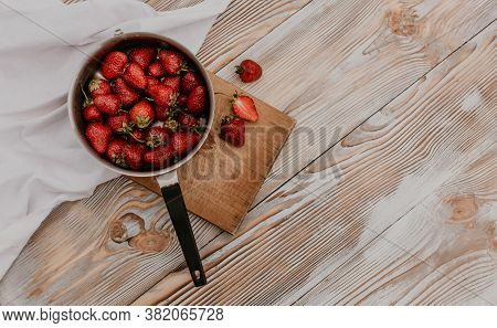 Juicy Red Strawberry Lies On The Wooden Board