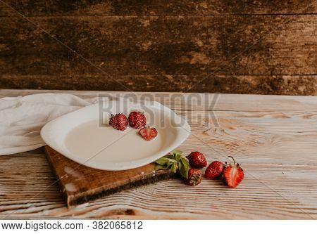 Juicy Red Strawberry Lies On The Wooden Board