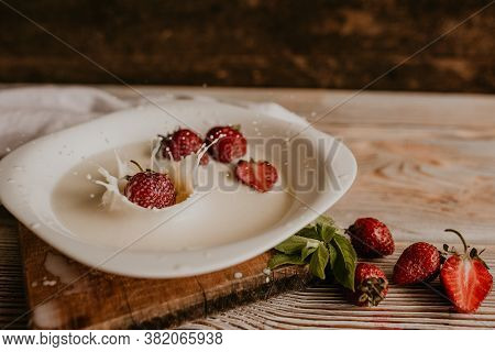 Juicy Red Strawberry Lies On The Wooden Board