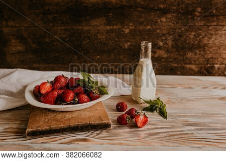 Juicy Red Strawberry Lies On The Wooden Board