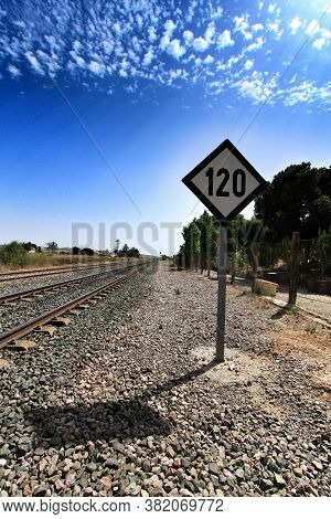 Speed Sign Limited To 120 Km Per Hour Next To Train Tracks In Spain