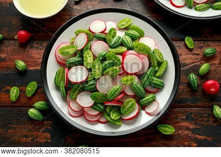 Cucamelon Radish Salad On Rustic Wooden Table. Healthy Summer Food