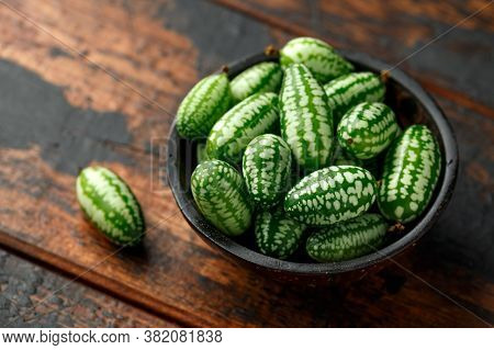 Freshly Picked Cucamelon In Rustic Bowl On Wooden Table