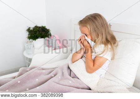 Toddler Girl Is Lying In Bed. The Child Is Cold And Sick And Has A Runny Nose And Snot. The Child Wi