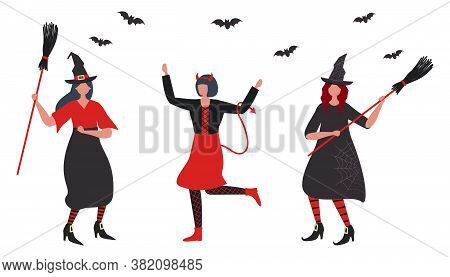 Halloween Party. Witches And Imp Dancing. Young Woman In Imp Costume. Two Women In Witch Costumes Wi
