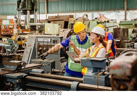 Mix Race Worker Working Together Help Each Other To Work In Heavy Industry Machine Wearing Safty Sui