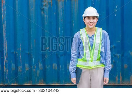 Portrait Of Young Woman Worker In Shipping Import Export Cargo Industry With Space For Text.