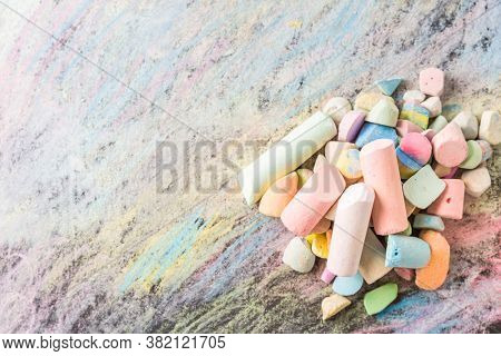 Chalks with colorful painted background. Back to school and art concept with copy space.