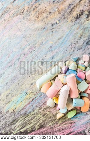 Chalks with colorful painted background. Back to school and art concept with copy space.