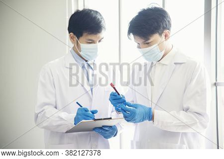 Two Asian Scientist Team Reserch Chemistry Science Tube Experiment Biotech Antibody Sample In Labora