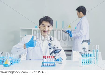 Two Asian Scientist Team Reserch Chemistry Science Tube Experiment Biotech Antibody Sample In Labora