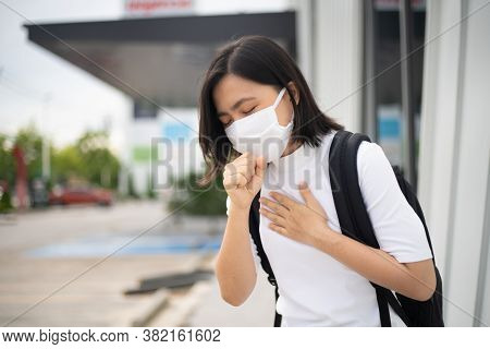 Asian Woman Wearing Protective Face Mask Coughing And Standing Department Store. New Lifestyle With