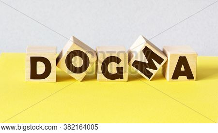Word Dogma Made From Building Blocks Isolated On Light Background