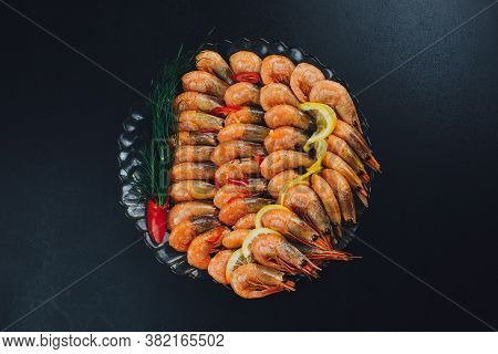 Shrimps With Lemon And Black Pepper On Dark Background
