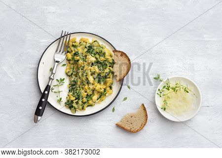 Scrumble Eggs With Kale And Cheese On A Light Gray Background, Top View. Delicious Homemade Breakfas