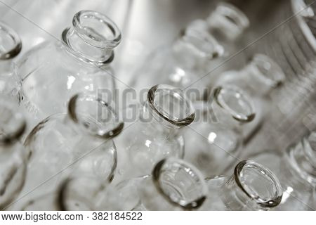 Empty Clear Glass Medicine Bottles. Medical Manufacturing Background