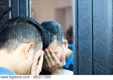 A Man With Hands On His Face In Front Of A Mirror In Depressed Mood With Selective Focus On Mirror I