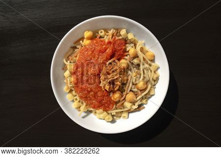 Famous Traditional Arabic, Egyptian Dish - Koshari. National Kushari In A White Plate On Dark Wooden