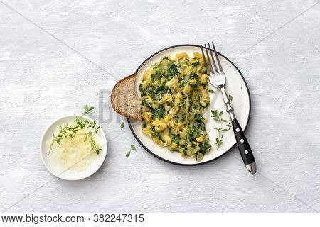 Scrumble Eggs With Kale And Cheese On A Light Gray Background, Top View. Delicious Homemade Breakfas
