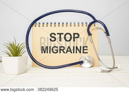 Text Stop Migraine In A Notebook On Medical Forms With A Phonendoscope And Green Pills. Medical Conz
