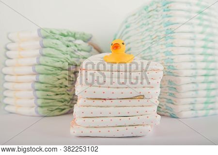 Baby Diapers On A White Background Close-up And Copy Space. Accessories For A Newborn Diapers, Pacif