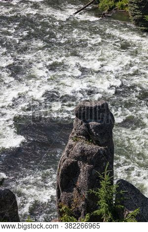 A Rock Pillar Stick Up Next To A Wild Section Ofhenrys Fork Of The Snake River Near Upper Mesa Falls