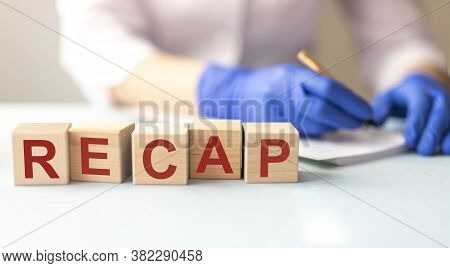 The Concept Of The Word Summarize On Cubes On A Medical Background, Doctor Holding Word Recap