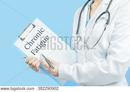 Chronic Fatigue Text On Message Pad. Female Doctor Unrecognizable Pointing At The Clipboard. Blue Ba