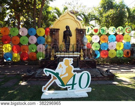 Bor Sang, Chiang Mai, Thailand, December 22, 2018: Image Of Buddha Between Umbrellas And The Logo Of