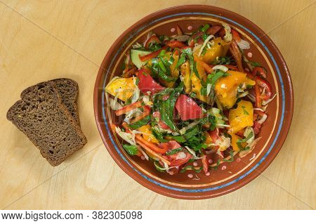 Top View On Ceramic Bowl Full Of Vegan Salad With Red Tomotoes, Cucumbers, Mangold , Parsley  Standi